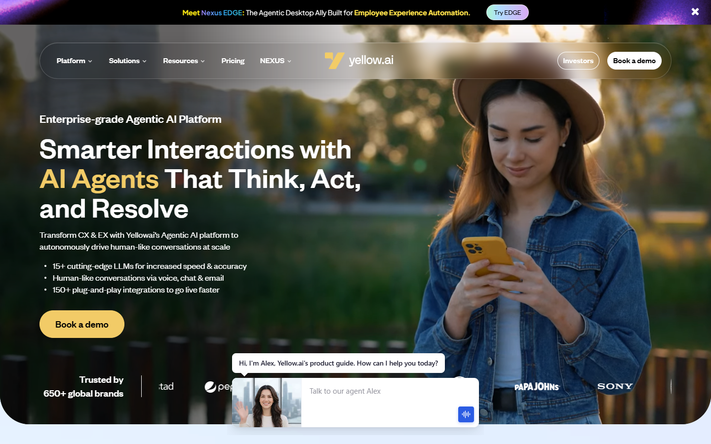 Yellow.ai homepage on agentic AI agents, showing a woman using a phone beside a live chat widget and brand logos.